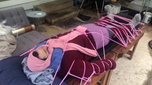 Wool mohair layers of sweaters on a bondage table